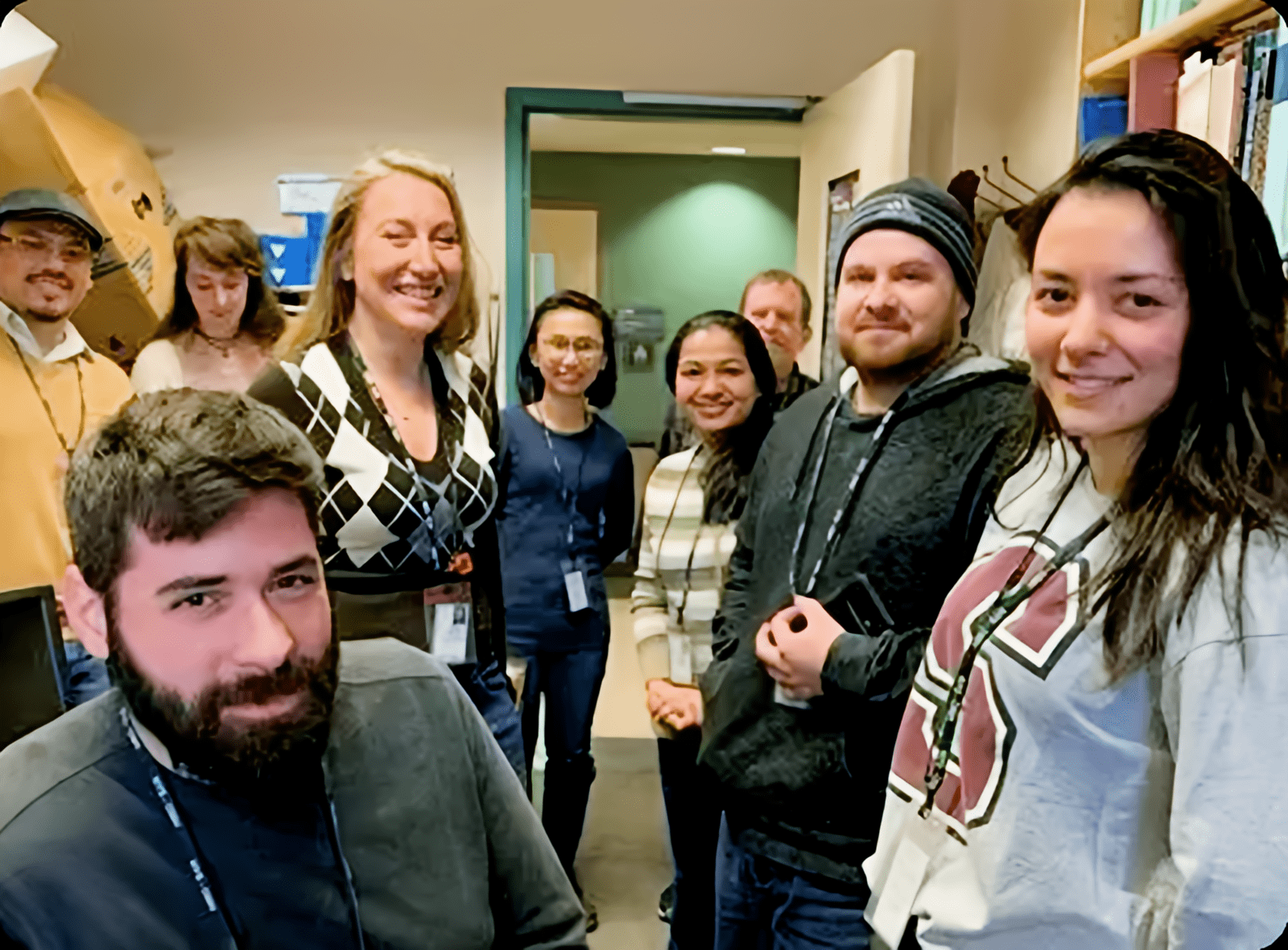 Group of people smiling in an office.