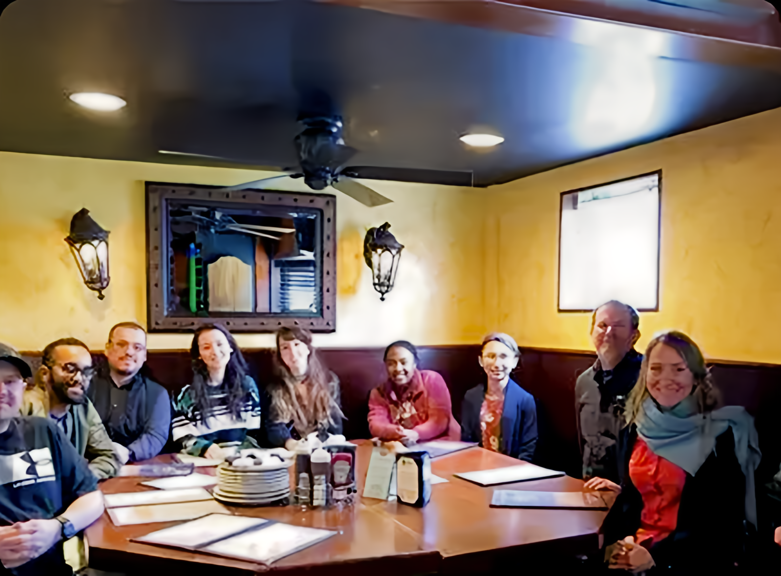 Group of people sitting around a table.